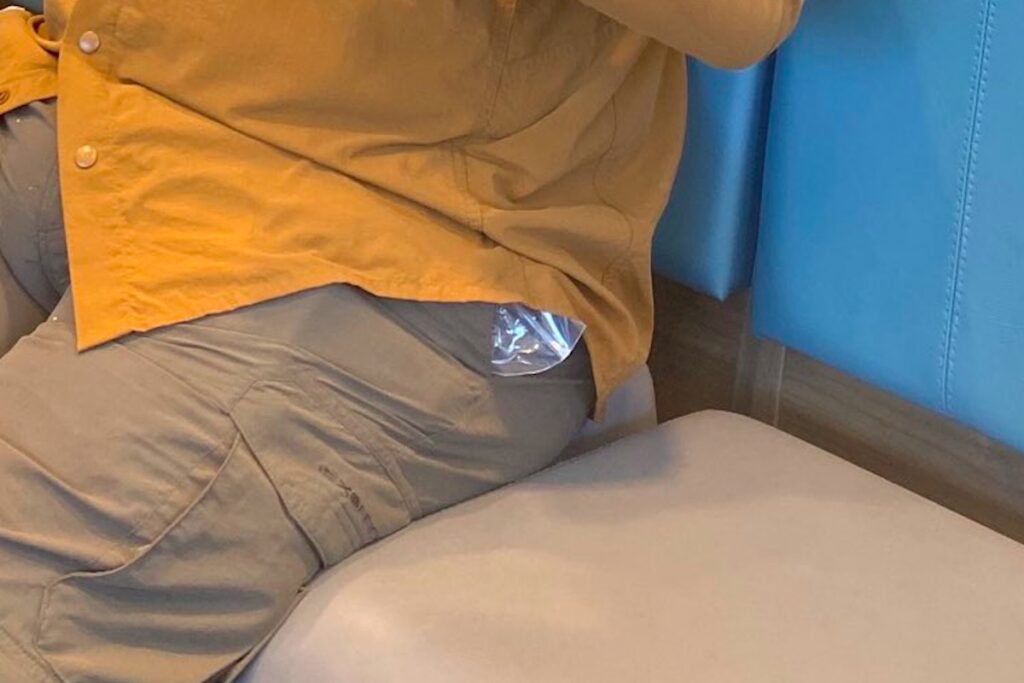 zoomed in photo of a plastic bag sticking out of Steve Harvey's pocket