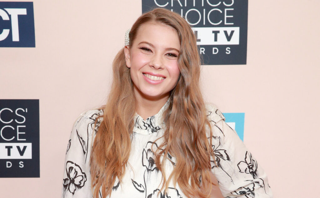 Bindi Irwin smiling in a black and white dress