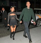 Kourtney Kardashian and Travis Barker hold hands as they arrive at Zero Bond